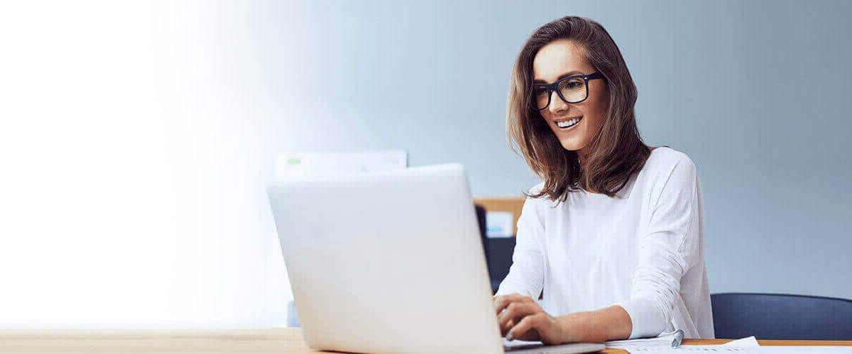 Smiling customer using a laptop to contact our authorized LG reseller